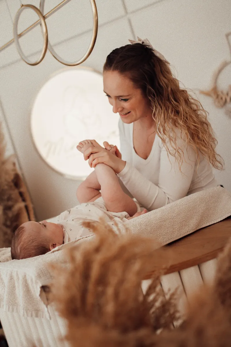 Julia macht ein Baby auf der Wickelkommode im Baby Spa fertig